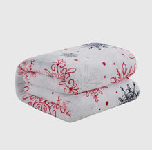 Load image into Gallery viewer, Winter throw blanket  with red and black snow flakes  on a white background
