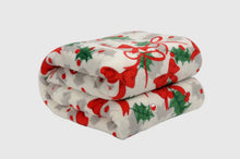 Load image into Gallery viewer, Folded blanket with red bows and green holly leaves on a white background
