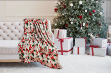 Load image into Gallery viewer, Decorative blanket with festive pattern in front of a Christmas tree and presents.
